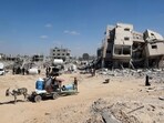 Palestinians who retuned briefly to eastern Deir al-Balah in the central Gaza Strip to check on property, carry away some items they were able to salvage amid the devastation. Palestinians who retuned briefly to eastern Deir al-Balah in the central Gaza Strip to check on property, carry away some items they were able to salvage amid the devastation.