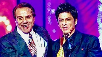 Dharmendra and Shah Rukh Khan pose together in this old photo. Dharmendra and Shah Rukh Khan pose together in this old photo.