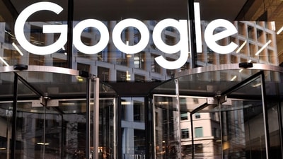 A logo is pictured above the entrance to the offices of Google in London. (AFP)