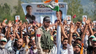 Anantnag: A security official stands guard as supporters cheer during a joint public meeting of Congress and National Conference ahead of the Jammu and Kashmir Assembly elections, in Anantnag district, Wednesday, Sept. 4, 2024. (PTI Photo/S Irfan) (PTI09_04_2024_000278A) (PTI) Anantnag: A security official stands guard as supporters cheer during a joint public meeting of Congress and National Conference ahead of the Jammu and Kashmir Assembly elections, in Anantnag district, Wednesday, Sept. 4, 2024. (PTI Photo/S Irfan) (PTI09_04_2024_000278A) (PTI)