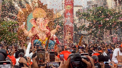 In Nagpur, devotees participated in a procession carrying a Lord Ganesha idol to a pandal on the eve of Ganesh Chaturthi. (PTI) In Nagpur, devotees participated in a procession carrying a Lord Ganesha idol to a pandal on the eve of Ganesh Chaturthi. (PTI)