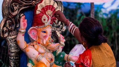 In New Delhi, a woman artist applied the final touches to a clay idol of Lord Ganesha, which was on display for sale, on Saturday. (PTI) In New Delhi, a woman artist applied the final touches to a clay idol of Lord Ganesha, which was on display for sale, on Saturday. (PTI)