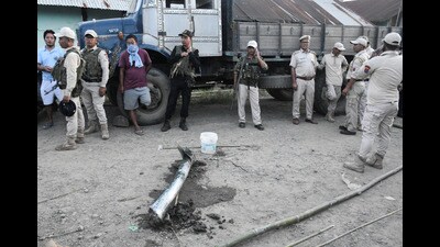Police personnel and locals stand near the remains of a missile after it struck in Manipur’s Moirang on Friday. (REUTERS) Police personnel and locals stand near the remains of a missile after it struck in Manipur’s Moirang on Friday. (REUTERS)