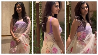 Pooja Hedge embraced a floral vibe, wearing a sheer white saree with floral prints. She paired it with a sleeveless purple blouse. Her outfit exuded a dainty feminine aesthetic. (Instagram/@voompla ) Pooja Hedge embraced a floral vibe, wearing a sheer white saree with floral prints. She paired it with a sleeveless purple blouse. Her outfit exuded a dainty feminine aesthetic. (Instagram/@voompla )