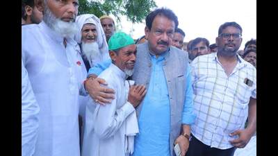 Union minister of state Prof SP Singh Baghel consoling a villager in Semra on Saturday. (HT Photo)