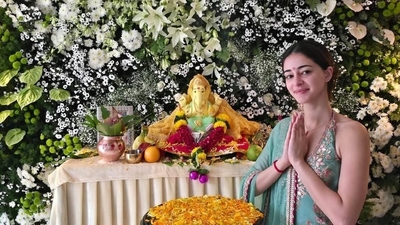 Ananya Panday smiled and posed for the camera in front of the Ganesh Pooja decorations. 