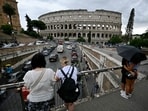 Tourists stand on a bridge near the Colosseum on July 3, 2024 in Rome. (Photo by Filippo Monteforte/AFP) Tourists stand on a bridge near the Colosseum on July 3, 2024 in Rome. (Photo by Filippo Monteforte/AFP)