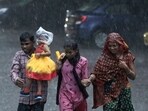 A family run as they cross a street during heavy rain in Hyderabad, India, Friday, Sept. 6, 2024. A family run as they cross a street during heavy rain in Hyderabad, India, Friday, Sept. 6, 2024.