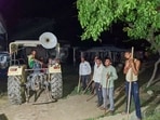 Bahraich: Locals stand guard with sticks and rods to keep a vigil amid wolf attacks, at Orahi village, in Bahraich district, early Wednesday, Sept. 4, 2024. As Uttar Pradesh's Bahraich grapples with wolf terror, an expert has said the series of attacks on the residents of Mehsi tehsil might be due to wolves "seeking revenge" for possible habitat loss or killing of their cubs. (PTI Photo) (PTI09_04_2024_000398A)