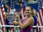 Aryna Sabalenka celebrates with the US open trophy.