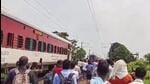 People gather after the Magadh Express train split into two parts after an accident in Bihar’s Buxar on Sunday. (PTI)