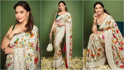 Madhuri Dixit, a true saree enthusiast, recently dazzled in a white saree adorned with vibrant prints and silver borders. Paired with a sleeveless green blouse, she looks absolutely breathtaking. (Instagram) Madhuri Dixit, a true saree enthusiast, recently dazzled in a white saree adorned with vibrant prints and silver borders. Paired with a sleeveless green blouse, she looks absolutely breathtaking. (Instagram)