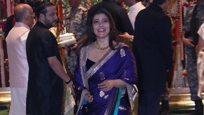 Kajol was seen in a blue and golden saree as she smiled and posed for the paparazzi. 
