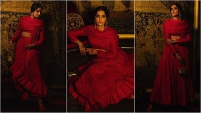 Sonam Kapoor dazzled in a stunning red ensemble by Abu Jani and Sandeep Khosla. The outfit featured an ankle-length pleated skirt in luxurious crushed silk, paired with a dramatic short choli with a crisscross back and long golden jhumkas for a touch of sparkle. (Instagram) Sonam Kapoor dazzled in a stunning red ensemble by Abu Jani and Sandeep Khosla. The outfit featured an ankle-length pleated skirt in luxurious crushed silk, paired with a dramatic short choli with a crisscross back and long golden jhumkas for a touch of sparkle. (Instagram)