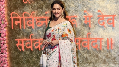 Madhuri Dixit opted for an embroidered white saree and green blouse. 