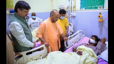 Lucknow: Uttar Pradesh Chief Minister Yogi Adityanath meets injured people at the Lok Bandhu hospital a day after the collapse of a building in Transport Nagar area, in Lucknow. At least eight people died and over 25 others were injured in the incident. (PTI)