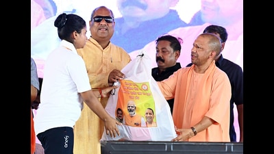 Uttar Pradesh Chief Minister Yogi Adityanath distributes sports kits to the members of Yuvak Mangal Dal and Mahila Mangal Dal during the foundation stone laying ceremony of 6,778 development projects worth ₹1,231 crore, in Ambedkar Nagar on Sunday. (ANI) Uttar Pradesh Chief Minister Yogi Adityanath distributes sports kits to the members of Yuvak Mangal Dal and Mahila Mangal Dal during the foundation stone laying ceremony of 6,778 development projects worth ₹1,231 crore, in Ambedkar Nagar on Sunday. (ANI)