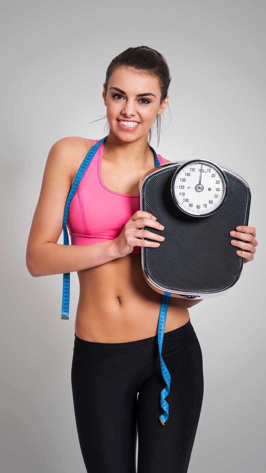 satisfied-fit-woman-with-weight-scale