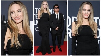 Angelina Jolie stunned at the Toronto International Film Festival in a sleek ruched black Dolce &amp; Gabbana gown, featuring a flowing semi-sheer floor-length skirt with a wavy train. She paired the look with matching opera gloves, adding a touch of timeless elegance. (Instagram/@JustJared)