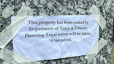 A DTCP notice outside of one of the buildings. (HT Photo)
