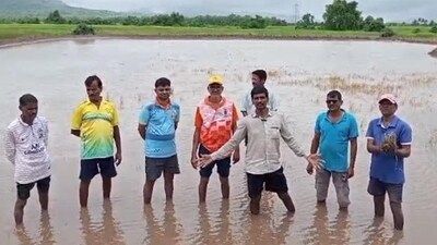 Bhagwan Jambhale (centre, hands spread), a local farmer who owns about 10 acres of land, said farmlands in the area are inundated with blackish water Bhagwan Jambhale (centre, hands spread), a local farmer who owns about 10 acres of land, said farmlands in the area are inundated with blackish water