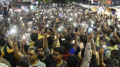 Citizens light mobile torch to mark their protest during a rally demand justice for the victim of RG Kar Medical College & Hospital at Shyambazar in Kolkata, on Sunday. (Samir Jana/HT Photo) Citizens light mobile torch to mark their protest during a rally demand justice for the victim of RG Kar Medical College & Hospital at Shyambazar in Kolkata, on Sunday. (Samir Jana/HT Photo)