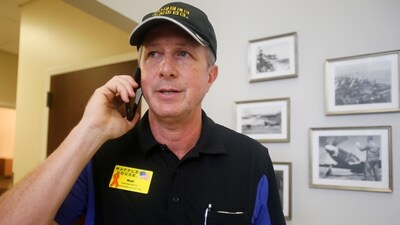 Walt Ehmer, president and CEO of Waffle House, speaks on the phone after landing at the Wilmington airport with an emergency response team in Wilmington, N.C., Sept. 17, 2018. (AP)