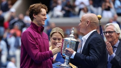 Former tennis player Andre Agassi presents the trophy to Italy's Jannik Sinner. (REUTERS)