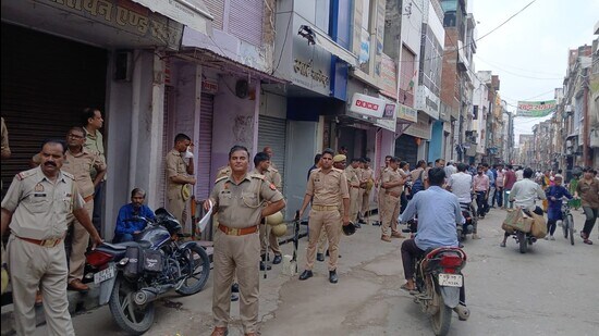 Police deployed in the closed main market of Kasganj on Sunday. (HT Photo)
