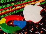 3D printed logos of Apple and Google are pictured on a keyboard in front of binary code in this illustration taken.
