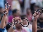 Kolkata: Junior doctors holding their stethoscope shout slogans as they sit on a dharna after the police stopped their march towards Swasthya Bhawan in protest over RG Kar Hospital rape and murder incident, in Kolkata, Tuesday, Sept. 10, 2024. (PTI Photo/Swapan Mahapatra) Kolkata: Junior doctors holding their stethoscope shout slogans as they sit on a dharna after the police stopped their march towards Swasthya Bhawan in protest over RG Kar Hospital rape and murder incident, in Kolkata, Tuesday, Sept. 10, 2024. (PTI Photo/Swapan Mahapatra)