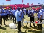 Workers of a Samsung facility drink tea as they gather to take part in a strike to demand higher wages at its Sriperumbudur plant near Chennai. 