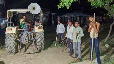 Locals stand guard with sticks and rods to keep a vigil amid wolf attacks, at Orahi village, in Bahraich district on September 4. (PTI) Locals stand guard with sticks and rods to keep a vigil amid wolf attacks, at Orahi village, in Bahraich district on September 4. (PTI)