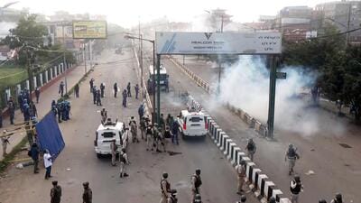 Paramilitary and police personnel stand guard during a student protest demanding the removal of the Manipur Director General of Police (DGP) and security advisor after the recent violence in different areas and districts, in Imphal on Tuesday. (ANI)