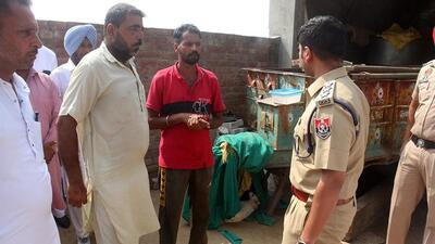 Police questioning residents after the double murder over a pet dog at Jeewan Singh Wala village in Bathinda district on Tuesday. (Sanjeev Singh/HT)