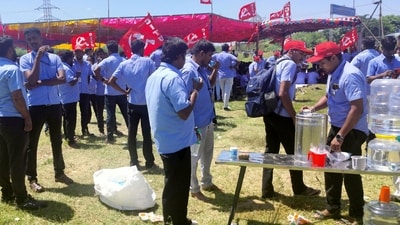 Workers of a Samsung facility drink tea as they gather to take part in a strike to demand higher wages at its Sriperumbudur plant near Chennai. (Reuters)