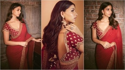 Suhana Khan dazzles in festive fashion with a stunning red saree by Torani Official. She paired the gorgeous six yards with an embellished sweetheart neckline blouse and a set of statement earrings, radiating glamour. (Instagram/@suhanakhan2) Suhana Khan dazzles in festive fashion with a stunning red saree by Torani Official. She paired the gorgeous six yards with an embellished sweetheart neckline blouse and a set of statement earrings, radiating glamour. (Instagram/@suhanakhan2)