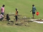 Groundsmen prepare the field with artificial grass before the start of the one-off Test cricket match between Afghanistan and New Zealand at the Shaheed Vijay Singh Pathik Sports Complex in Greater Noida Groundsmen prepare the field with artificial grass before the start of the one-off Test cricket match between Afghanistan and New Zealand at the Shaheed Vijay Singh Pathik Sports Complex in Greater Noida