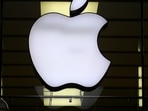 The Apple logo is illuminated at a store. The Apple logo is illuminated at a store.