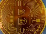 Signage for Bitcoin cryptocurrency is seen. 
