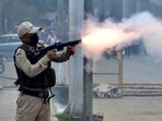 A police officer fires a tear smoke shell to disperse demonstrators during a protest march by the students demanding an end to the latest spurt of ethnic violence, in Imphal, Manipur, India, September 10, 2024. 