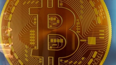 Signage for Bitcoin cryptocurrency is seen. (Bloomberg) Signage for Bitcoin cryptocurrency is seen. (Bloomberg)