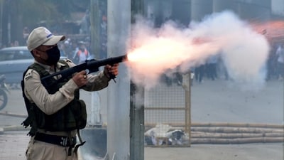 A police officer fires a tear smoke shell to disperse demonstrators during a protest march by the students demanding an end to the latest spurt of ethnic violence, in Imphal, Manipur, India, September 10, 2024. (REUTERS)