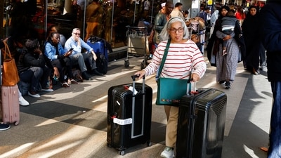 A passenger pushes her luggage as they wait for their flights during a strike by Kenya airports union workers to protest against a proposed deal for India's Adani Group ADEL.NS, to lease Jomo Kenyatta International Airport (JKIA) for 30 years, in Nairobi, Kenya. (Reuters)