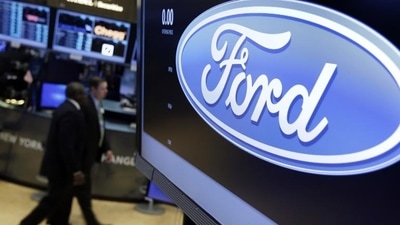 The logo for the Ford Motor Company appears above a post on the floor of the New York Stock Exchange. (AP) The logo for the Ford Motor Company appears above a post on the floor of the New York Stock Exchange. (AP)