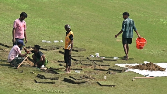 Groundsmen prepare the field with artificial grass before the start of the one-off Test cricket match between Afghanistan and New Zealand at the Shaheed Vijay Singh Pathik Sports Complex in Greater Noida (AFP)