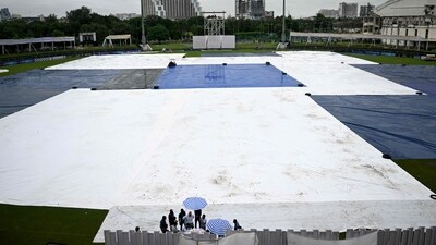 The covered field is pictured as it rains at the start of the one-off Test cricket match between Afghanistan and New Zealand at the Shaheed Vijay Singh Pathik Sports Complex in Greater Noida on September 12, 2024 (AFP) The covered field is pictured as it rains at the start of the one-off Test cricket match between Afghanistan and New Zealand at the Shaheed Vijay Singh Pathik Sports Complex in Greater Noida on September 12, 2024 (AFP)