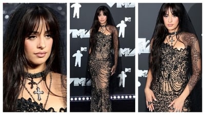 Camila Cabello returned to her iconic Havana-era brunette locks with curtain bangs. She embraced a gothic aesthetic, wearing a sheer and dainty black lace gown with a veil from Tony Ward Couture. In tandem with her gothic bridal look, she layered cross necklaces for that mysterious vibe. (Instagram) Camila Cabello returned to her iconic Havana-era brunette locks with curtain bangs. She embraced a gothic aesthetic, wearing a sheer and dainty black lace gown with a veil from Tony Ward Couture. In tandem with her gothic bridal look, she layered cross necklaces for that mysterious vibe. (Instagram)