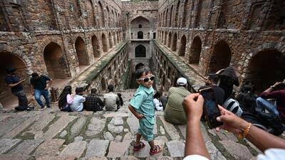 Visitors at Agrasen ki Baoli near Connaught Place on Wednesday. (RAJ K RAJ /HT PHOTO)