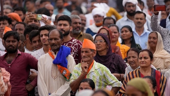 Supporters of the Bhartiya Janta Party (BJP) listen to the party candidates during a campaign rally after they filed nomination papers for the upcoming Jammu and Kashmir Assembly elections at Nagrota outskirts of Jammu, India, Thursday, Sep.12, 2024. (AP Photo/Channi Anand) (AP)